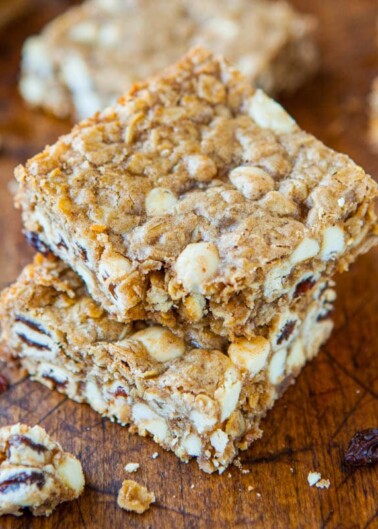 Stack of homemade cereal bars on a wooden surface.