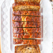 Sliced banana bread served on a white rectangular platter.
