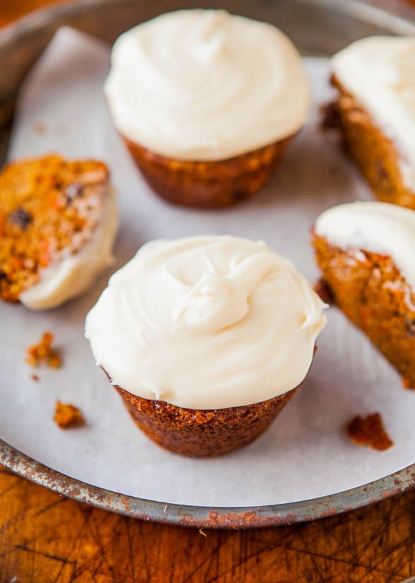 Carrot Cake Cupcakes with Vanilla Cream Cheese Frosting on a white piece of paper