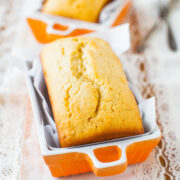 Freshly baked loaf cake in an orange ceramic baking dish.