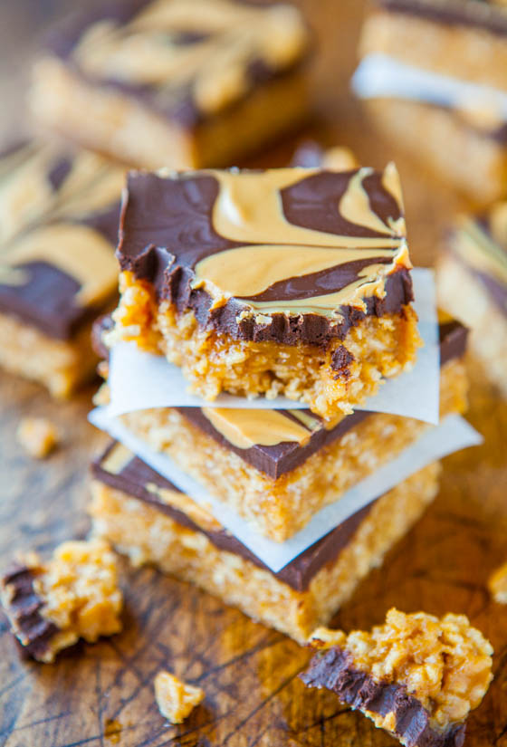 Stacked Chewy Peanut Butter and Chocolate Cereal Bars separated by parchment paper