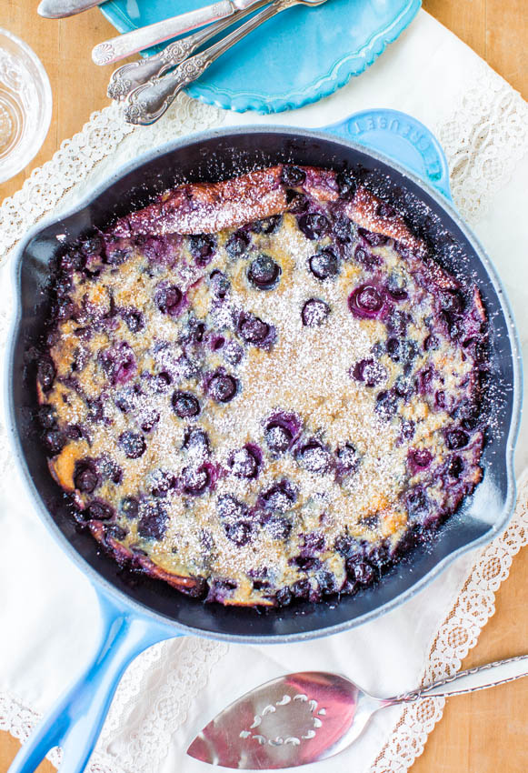 overhead view of a blueberry dutch baby pancake in a skillet