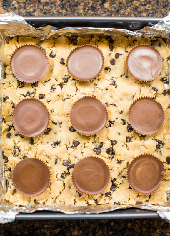 Easy Chocolate Chip Cookie Bars (with PB Cups!) — Looking for things to do with store-bought cookie dough? Look no further! These are the ultimate lazy chocolate chip cookie bars and everyone LOVES them! 