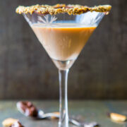 Chocolate martini with a crushed biscuit rim served in a stemmed glass.