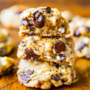 Stack of chocolate chip cookies with visible chunks of chocolate and cookie pieces.