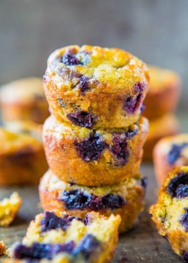 A stack of blueberry muffins with visible berries and a golden-brown crust.