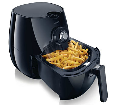 Black air fryer with french fries inside the basket.