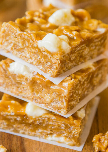 Stack of peanut brittle squares on parchment paper.