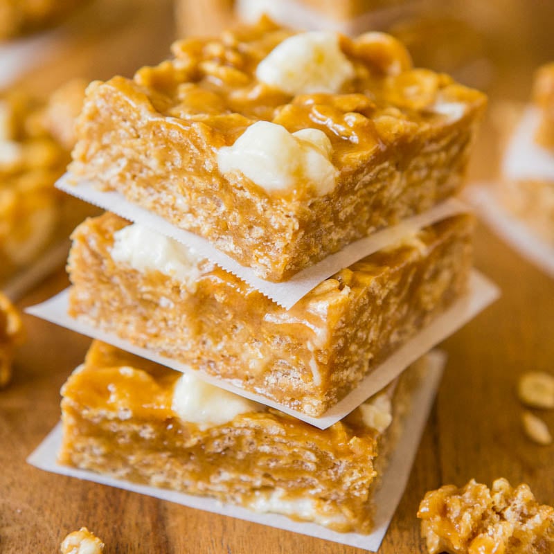 Stack of peanut brittle squares on parchment paper.