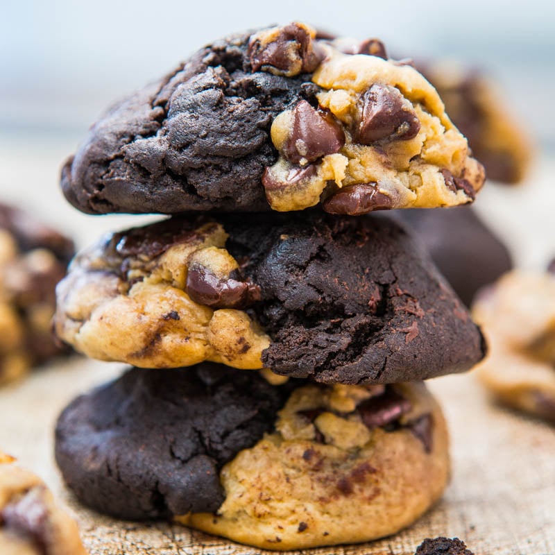 A stack of chocolate chip cookies with one half classic dough and the other half chocolate dough.