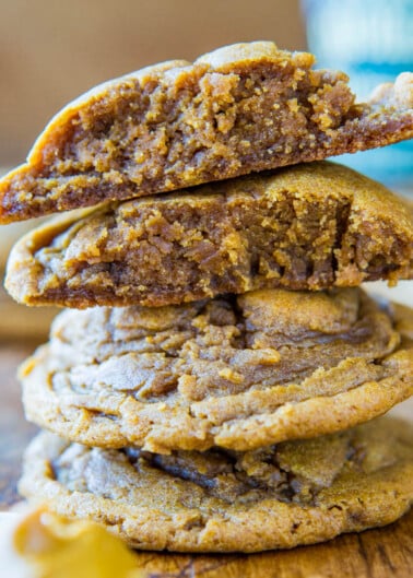 A stack of chewy cookies with one split open to show the soft interior.