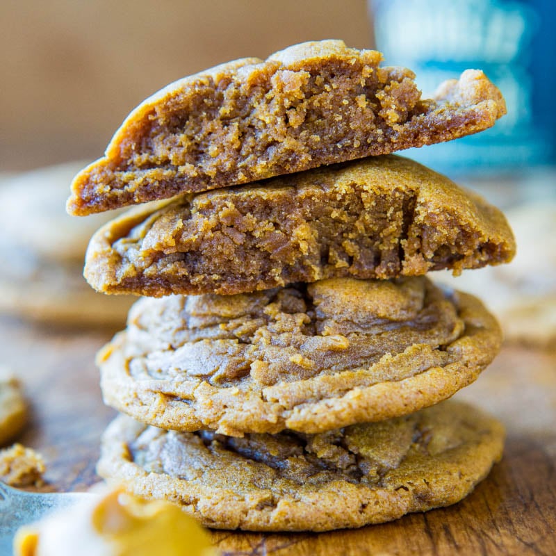 A stack of chewy cookies with one split open to show the soft interior.