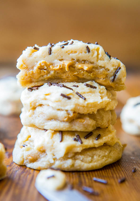 Lofthouse-Style Frosted Peanut Butter Chip Sugar Cookies stack on a wooden table