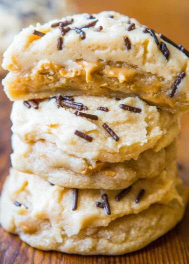 A stack of cookies with caramel filling and chocolate sprinkles on top.
