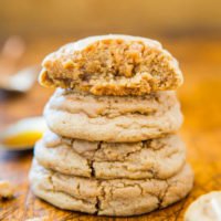 Stack of homemade peanut butter cookies on a wooden surface.