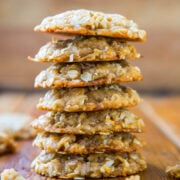 A stack of oatmeal cookies on a wooden surface.