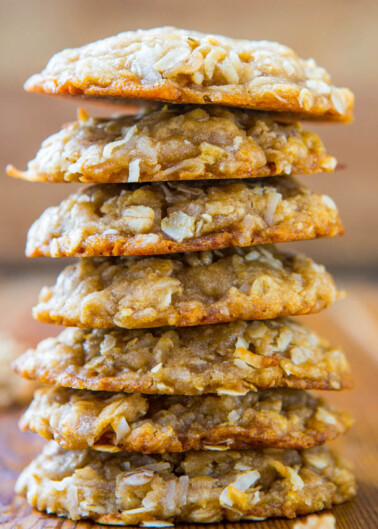 A stack of oatmeal cookies on a wooden surface.