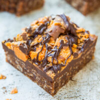 Chocolate fudge topped with caramel, nuts, and a drizzle of chocolate.