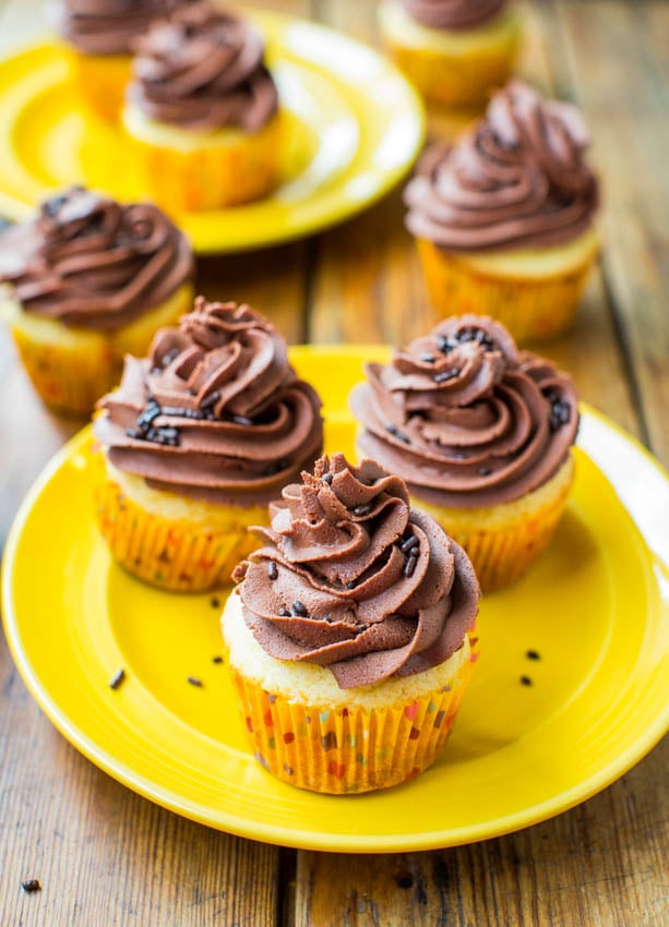Yellow Cupcakes with Chocolate Buttercream Frosting — These from-scratch yellow cupcakes with chocolate buttercream frosting taste just like the kind you grew up eating at childhood birthday parties!