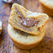 A heart-shaped cookie with a chocolate filling atop a circular cookie.