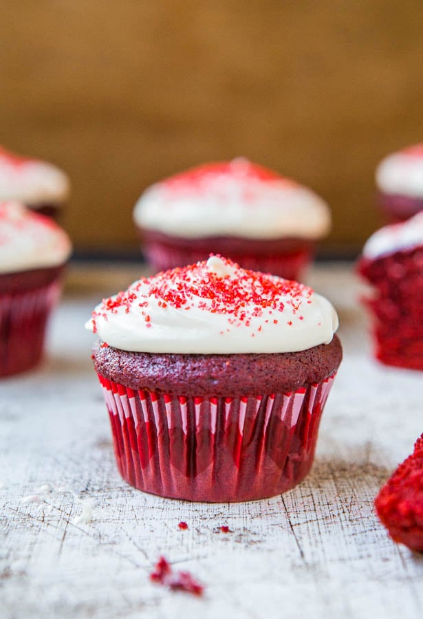 Red Velvet Cupcakes with Vanilla Cream Cheese Frosting on a wooden table