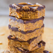 A stack of peanut butter chocolate bars on a wooden surface.