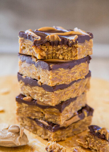 A stack of peanut butter chocolate bars on a wooden surface.