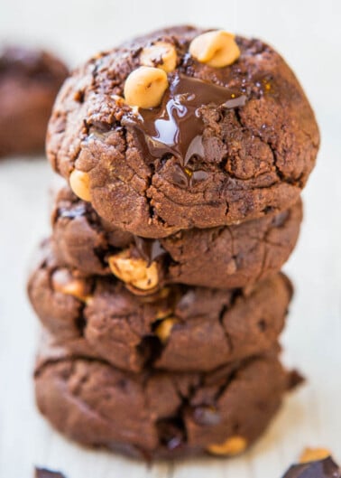 A stack of chocolate peanut butter cookies with melting chocolate visible.