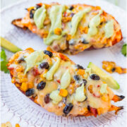Three images of baked sweet potatoes topped with melted cheese, black beans, corn, and avocado served on a white plate with lime wedges on the side.