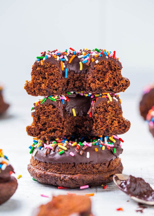 three chocolate sprinkle donuts stacked on top of each other