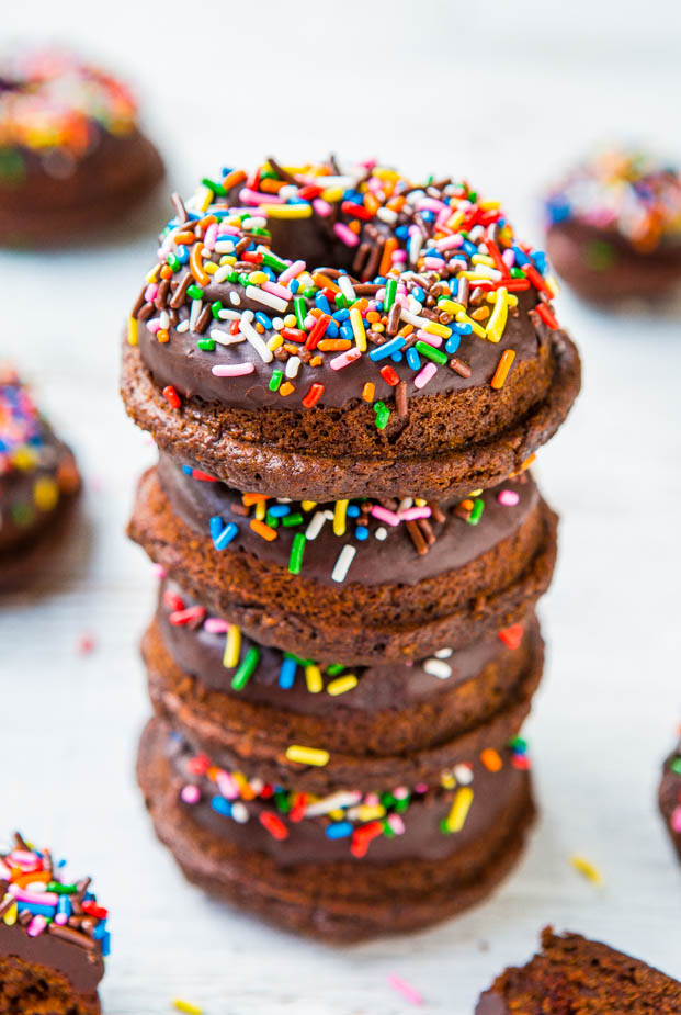 stack of four chocolate frosted donuts
