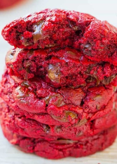 A stack of red velvet cookies with chocolate chips.