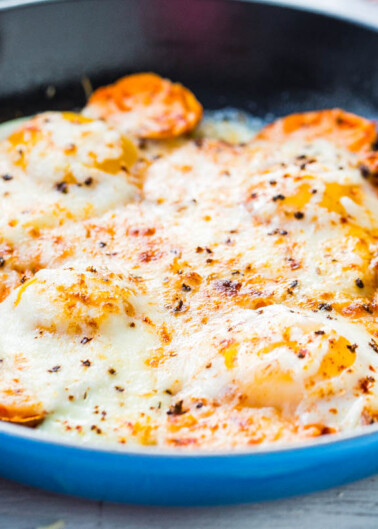 A skillet of baked cheesy sweet potatoes.