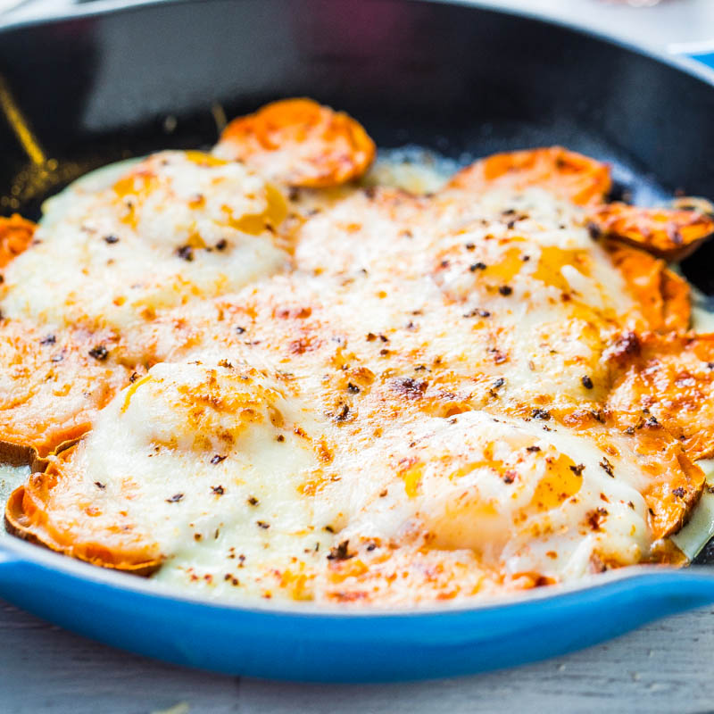 A skillet of baked cheesy sweet potatoes.