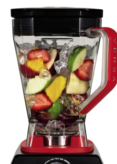 A blender filled with fruits and ice, ready to mix.