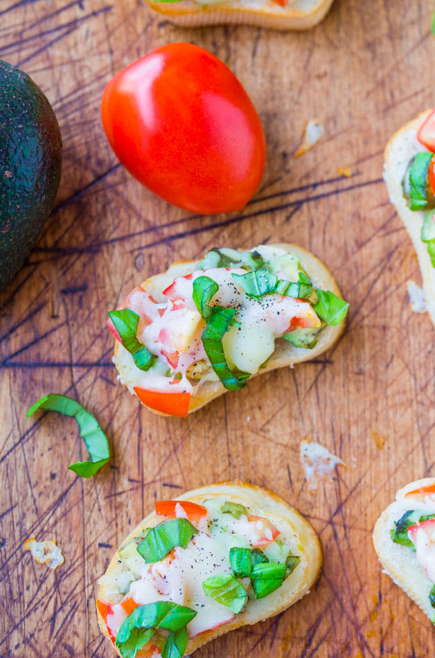 Avocado, Tomato, and Mozzarella Crostini - Like bruschetta, but with avocado & who can say no to avocado and cheese! A fast & easy appetizer everyone loves & ready in 15 minutes!