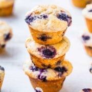 A stack of blueberry muffins on a light background.