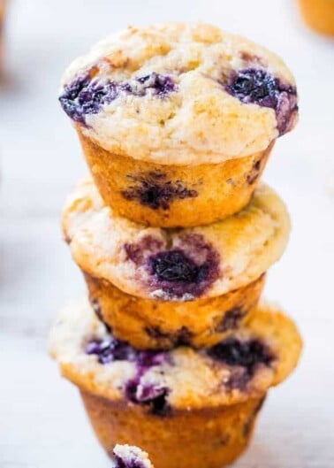 A stack of blueberry muffins on a light background.