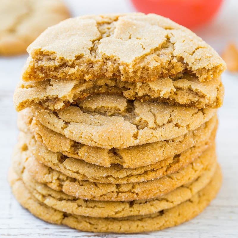 A stack of golden-brown, crispy-edged peanut butter cookies.