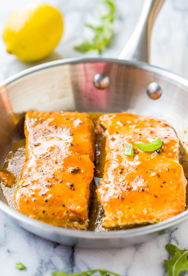 two bbq salmon fillets in a metal skillet 