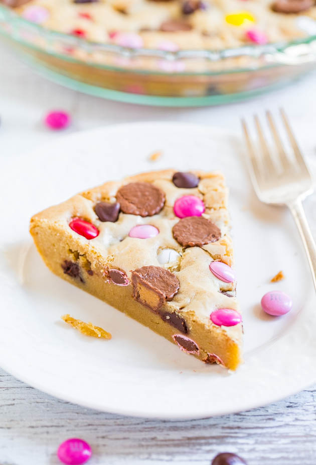 Soft and Chewy Loaded Candy Bar Pie — If you like M&M's cookies, you'll love this biggie version! Super easy and loaded with M&M's, Rolos, PB cups, and more!