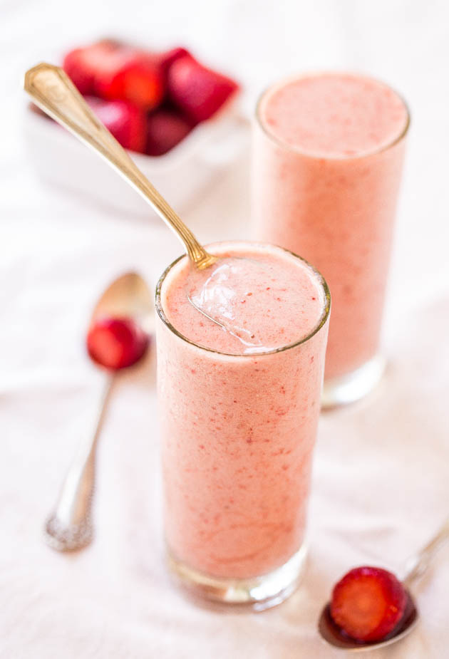 two glasses of Banana Strawberry Pineapple Smoothie with spoons