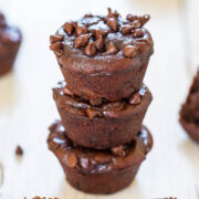 Three chocolate muffins stacked with chocolate chips on top.