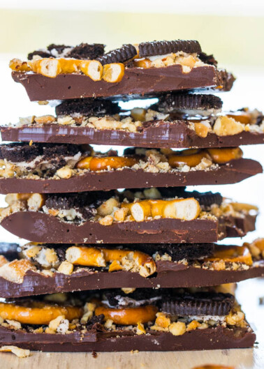 Stack of homemade chocolate bark with pretzels and crushed cookies.