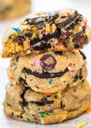 A stack of chocolate chip cookies with colorful sprinkles and an oreo cookie baked into the center.