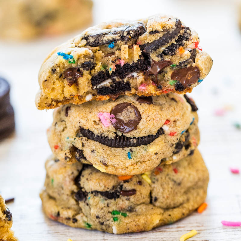 A stack of chocolate chip cookies with colorful sprinkles and an oreo cookie baked into the center.
