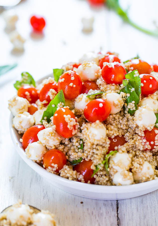 close up of Tomato Mozzarella Salad with Basil and Quinoa in a large white bowl