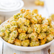 A bowl of crispy breaded okra on a wooden surface.