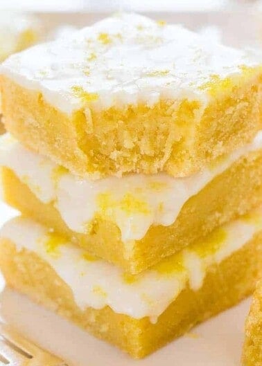 A stack of lemon bars with a dusting of powdered sugar.