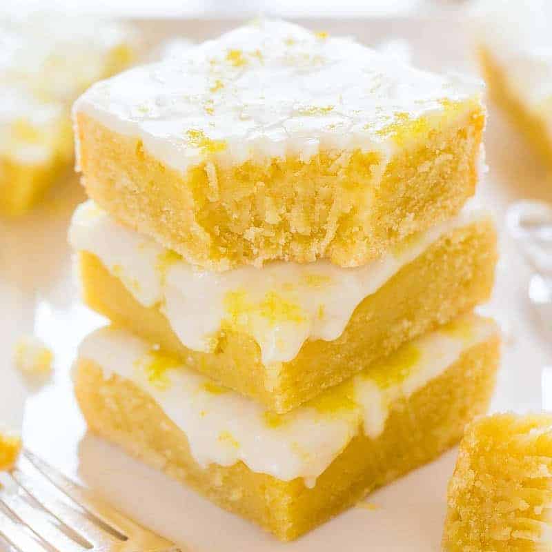 A stack of lemon bars with a dusting of powdered sugar.